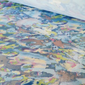 Lycra avec un effet brillant mouillé. Motif rappelant des flaques d'eau. Envers blanc.